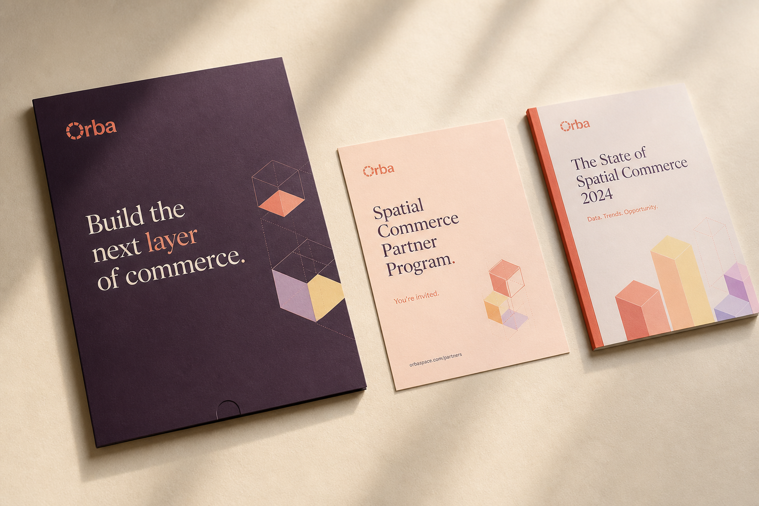 Orba partner-facing collateral applying the identity across printed materials